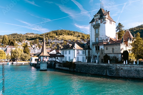 Landscape of the Oberhofen Castle at the shore on the background of the green hills photo