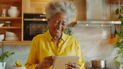 Elderly Woman Using Tablet in Kitchen photo