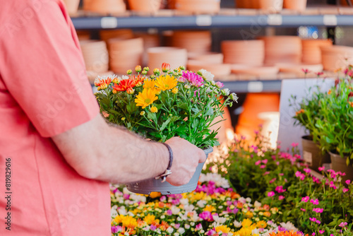 Man choosing colorful flowers at a garden center
