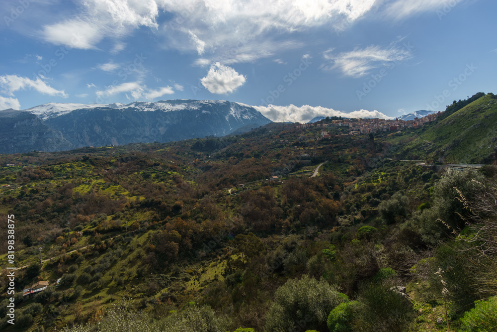 Fototapeta premium View of valley and the high mountains of the Madonie Nature Park with town of Isnello on a sunny day, Isnello, Sicily, Italy