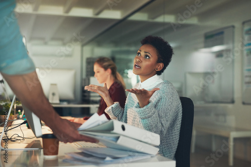 Frustrated, woman and work on files in administration with anger from stress or late deadline. Overworked, overwhelmed and secretary complaining with paperwork, documents and problem with project