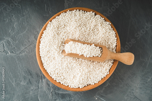 White Sago Pearls in Wooden Bowl Also Know as Sabudana, Tapioca Pearl or Sago Seeds isolated on Gray Background photo