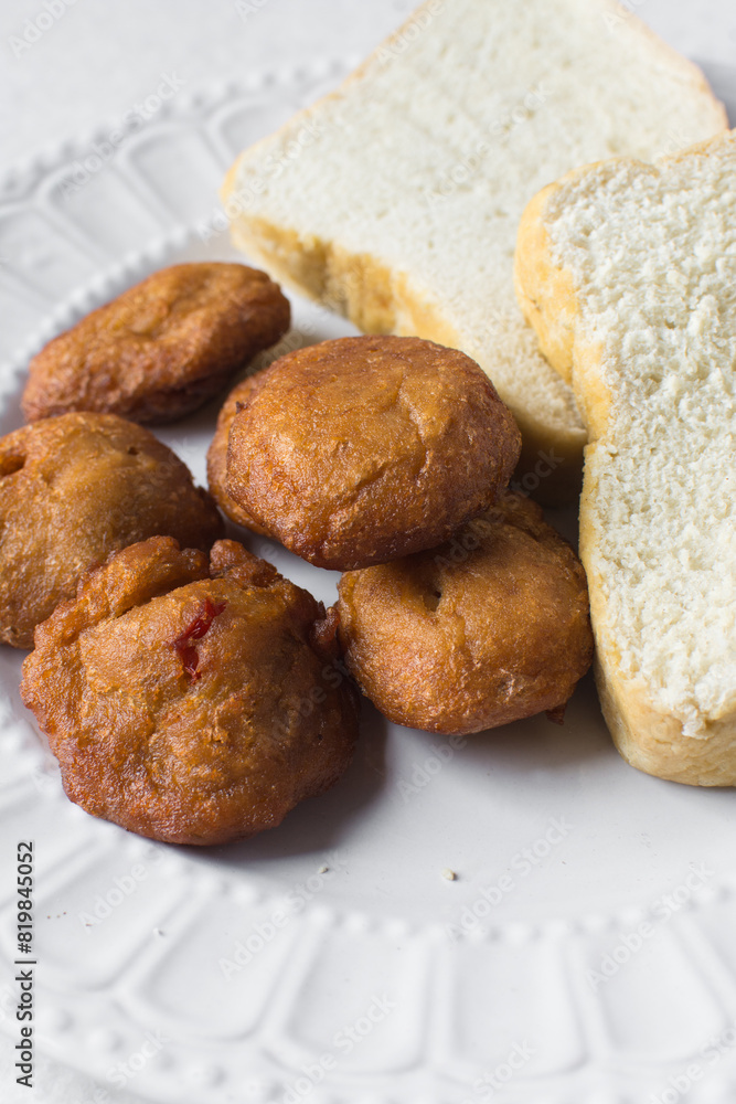 Akara and bread on a white plate, nigerian akara fried beans cake and bread on a plate 