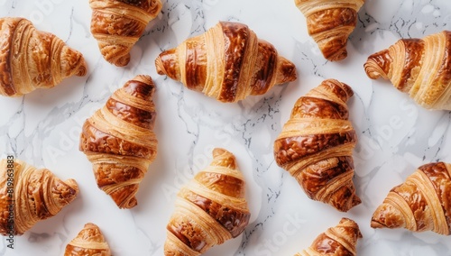 Fresh croissants on cloth on a trendy marble table.