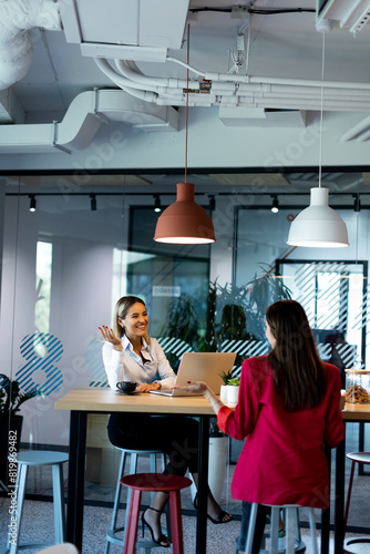 Two women collaborating in ...