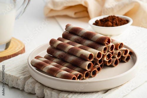 Chocolate cream flavour wafers sticks or wafer rolls in white plate.snack food.