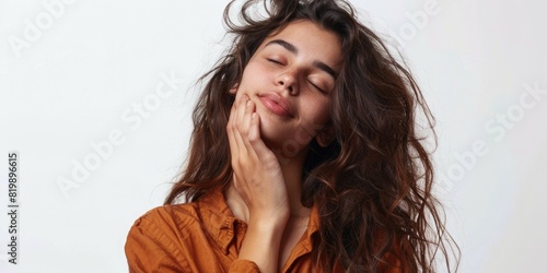 A woman with closed eyes and hand on chin. Suitable for lifestyle or mental health concepts