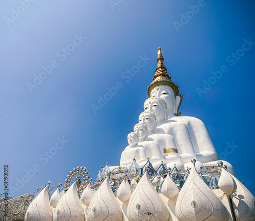 The big white Buddha five statue,Phetchabun is one of the top Thailand famous temples with a huge five white jade buddhas layered statue,Wat Phra That Pha Kaew, Phetchabun,Five white Buddha statue. photo