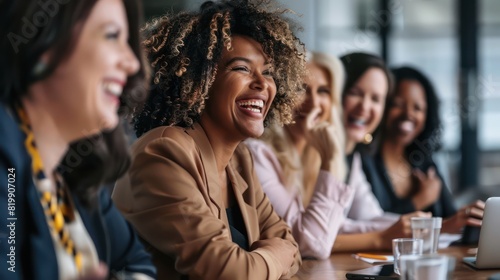 A group of diverse businesswomen gathered around a conference table  sharing laughter and ideas. 
