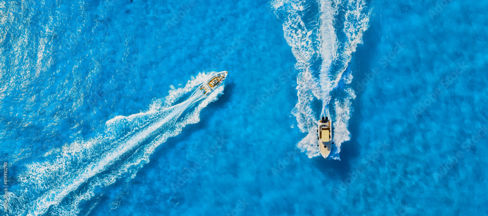 Vacation and leisure. Drone view on fast boat on blue Mediterranean sea at sunny day. Fast ship on the sea surface. Seascape from the drone. Seascape from air. Seascape with motorboat.