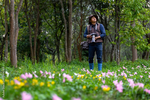 Konstfotografi Photographer is taking photo while exploring in the woodland forest with wild fl