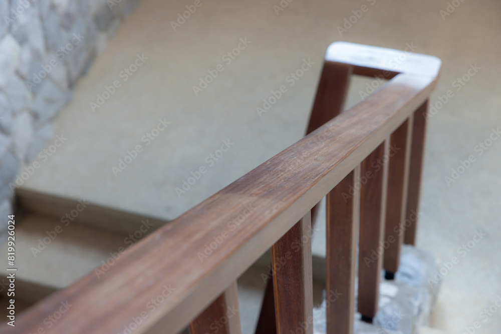 A wooden railing with a stone floor A wooden railing with a stone floor