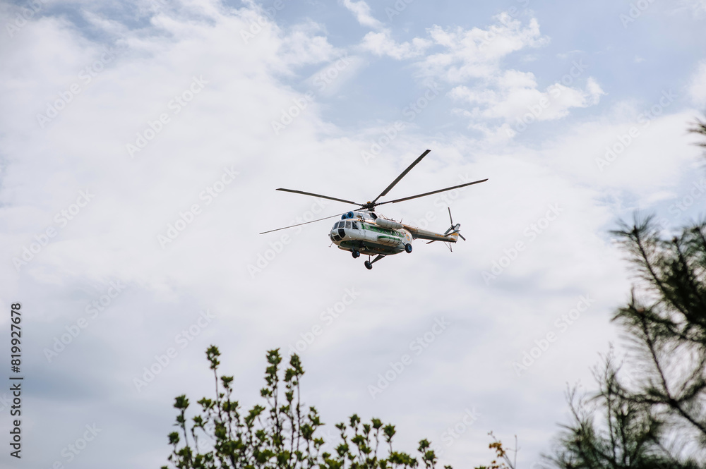 Fototapeta premium A Ukrainian medical helicopter flies in the sky, conducting a rescue operation, helping people. Photography, war in Ukraine.