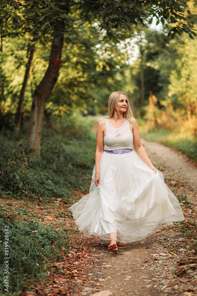 Beautiful blonde lady woman in white dress outdoors