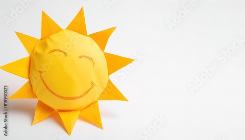 life, light, energy, and spirituality concept of paper origami isolated on white background of the sun with smiley face with copy space, simple starter craft for kids