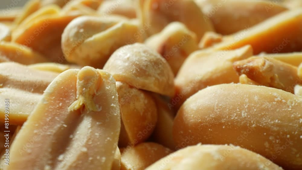 Behold the close-up spectacle of roasted peanuts, gleaming with a golden-brown sheen. Split in halves, they disclose their velvety essence, adorned with glistening salt crystals, tempting the senses.
Behold the close-up spectacle of roasted peanuts, gleaming with a golden-brown sheen. Split in halves, they disclose their velvety essence, adorned with glistening salt crystals, tempting the senses.