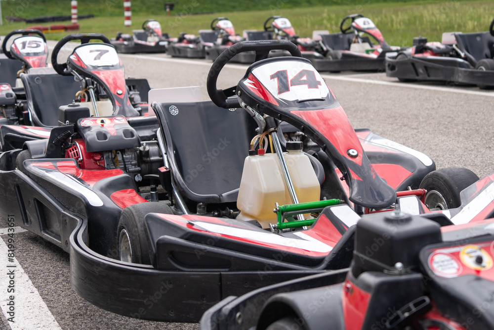 Red black go-karts on the side of a track Red black go-karts on the side of a track