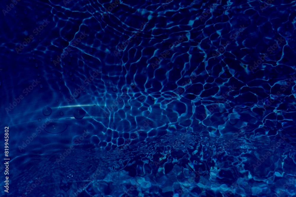 Title	
Blue water with ripples on the surface. Defocus blurred transparent blue colored clear calm water surface texture with splashes and bubbles. Water waves with shining pattern texture background.