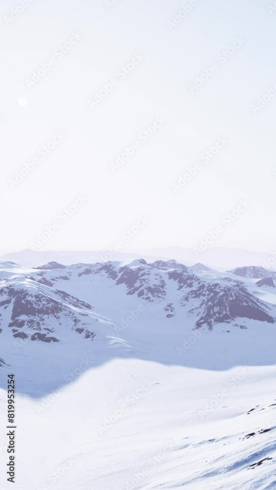 A view of a mountain range covered in snow A view of a mountain range covered in snow