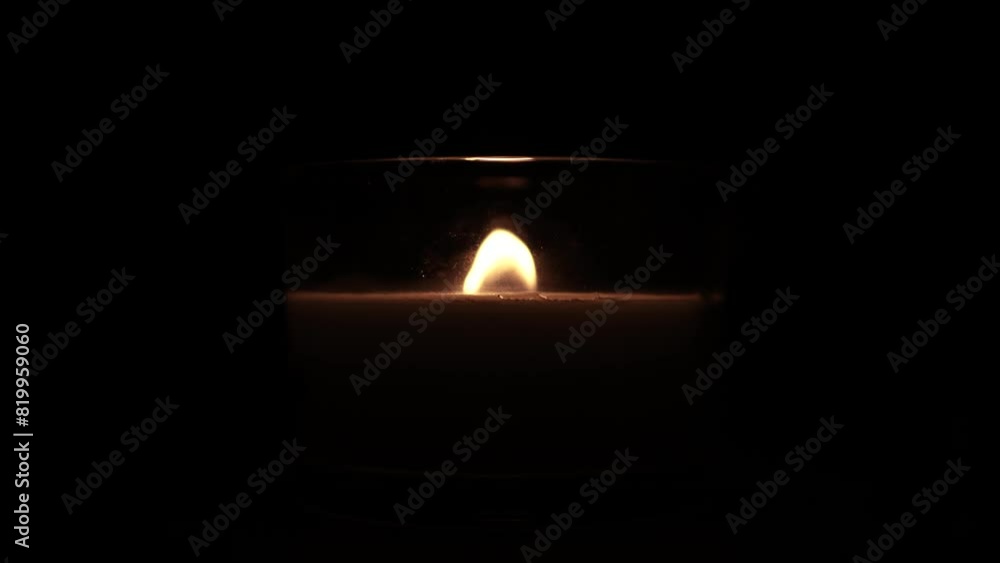 Candle light in the dark in church. Flickering Candle. Spiritual Atmosphere Candle light in the dark in church. Flickering Candle. Spiritual Atmosphere