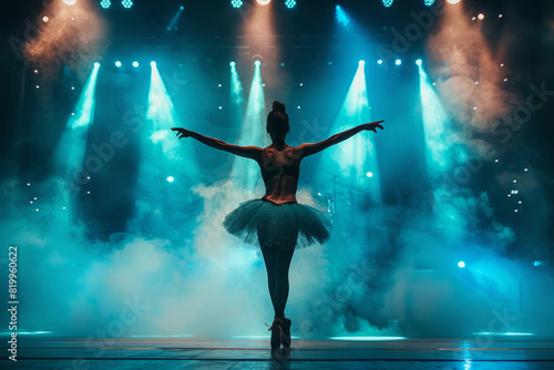 Young female ballerina performs on stage photo