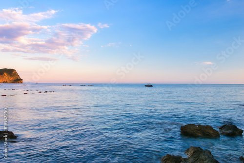 Budva, Montenegro - May 04, 2024 : The Old Town Fortress in Budva. A stone wall on the shore of the Adriatic Sea in Montenegro. Horizontal. On a hot, sunny, spring afternoon.