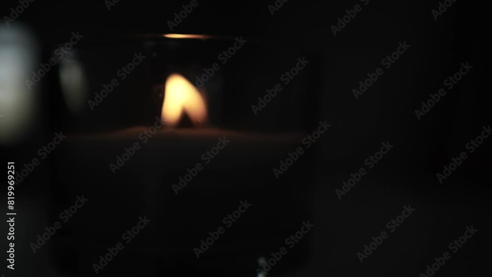 Candle light in the dark in church. Flickering Candle. Spiritual Atmosphere Candle light in the dark in church. Flickering Candle. Spiritual Atmosphere