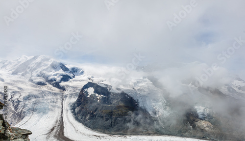 Panorama of stunning mountains and glaciers above, Switzerland. photo