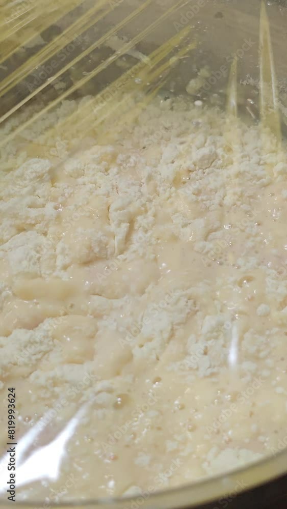 prepare sourdough for baking. Cover the dough with milk, yeast and flour with plastic wrap until it rises.