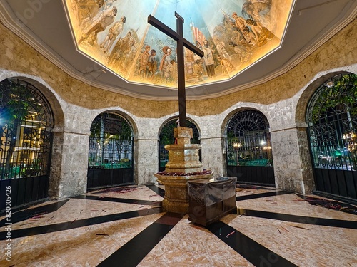 Cebu City, Philippines - May 12, 2024: The famed Magellan's Cross at night, showcasing its beautiful mural and historical significance inside a well-preserved stone structure.