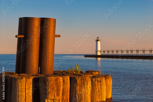 Mooring dolphin, lighthouse, and pier at sunrise