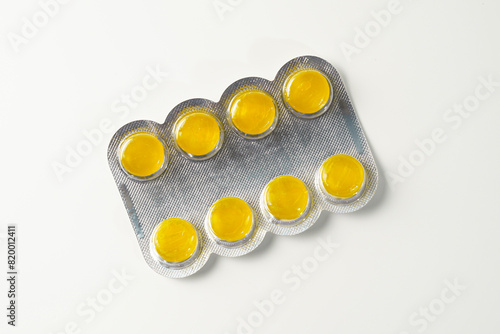 Medical candies lozenges in blister pack isolated on white background
