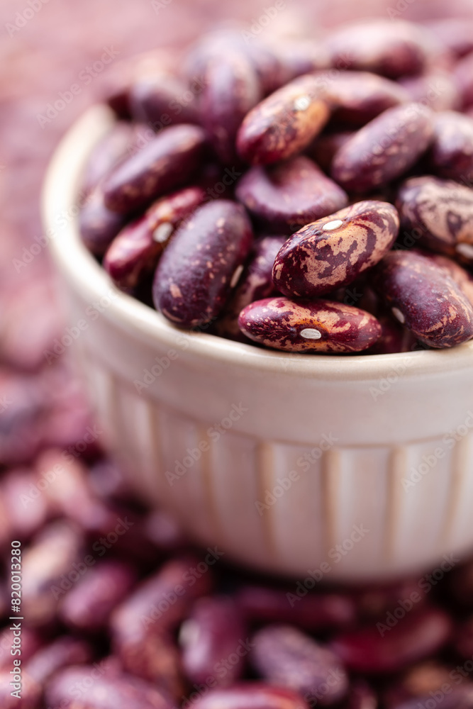 Uncooked variegated kidney bean seeds in bowl. Red and white dry beans Uncooked variegated kidney bean seeds in bowl. Red and white dry beans
