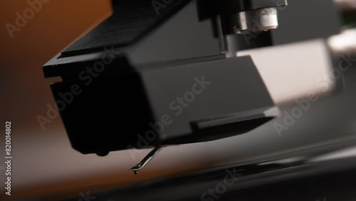 Turntable Stylus Attached to the Phono Cartridge Lowering onto the Spinning Vinyl Record in Macro and Slow Motion - Listening Room photo