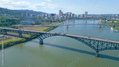 Blue skies and sunny day looking north from Ross Island towards the Portland, Oregon cityscape. Three bridges are in view as is a placid Willamette River. This is a 38 second slow pan right photo