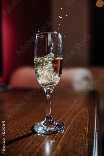 a splash of champagne from the glass where the wedding rings were thrown photo