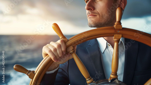 A professionally dressed businessman confidently steers a ship’s wheel, symbolizing the strategic navigation required in the business world.