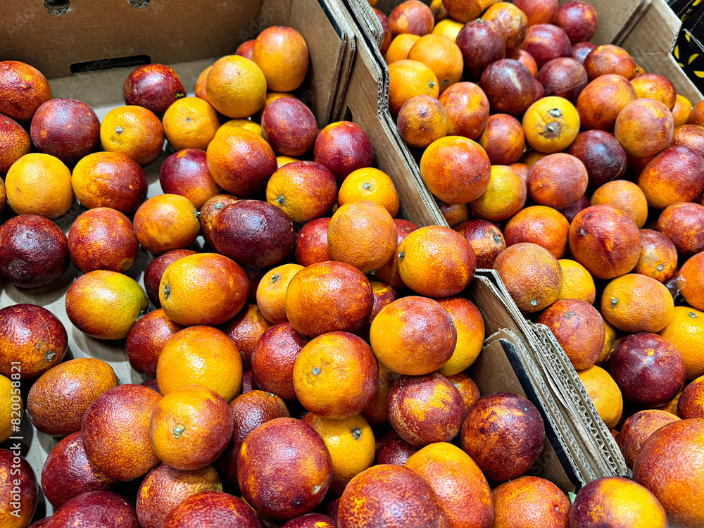 blood oranges lie on the counter in a grocery store, fruits for sale blood oranges lie on the counter in a grocery store, fruits for sale