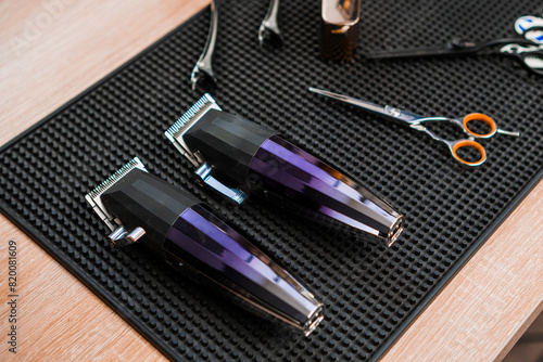 Trimmers, clippers and scissors on the table in the barbershop.  photo