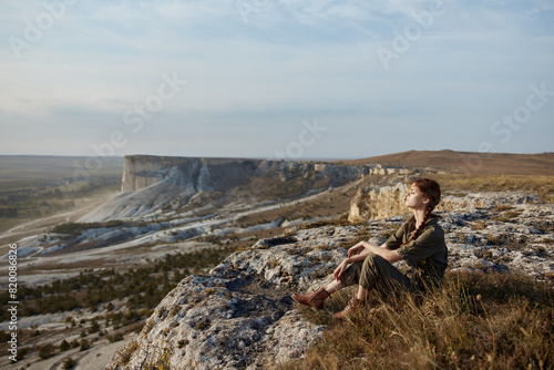 Woman contemplating majestic landscape of valley and mountains on cliff edge travel adventure concept © SHOTPRIME STUDIO