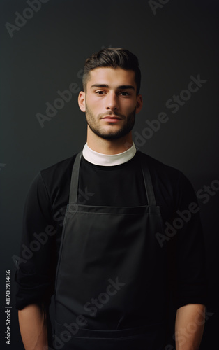A man in a kitchen apron. Chef work in the cuisine. Cook in uniform, protection apparel. Job in food service. Professional culinary. Black fabric apron, casual stylish clothing. Baker. Generated AI