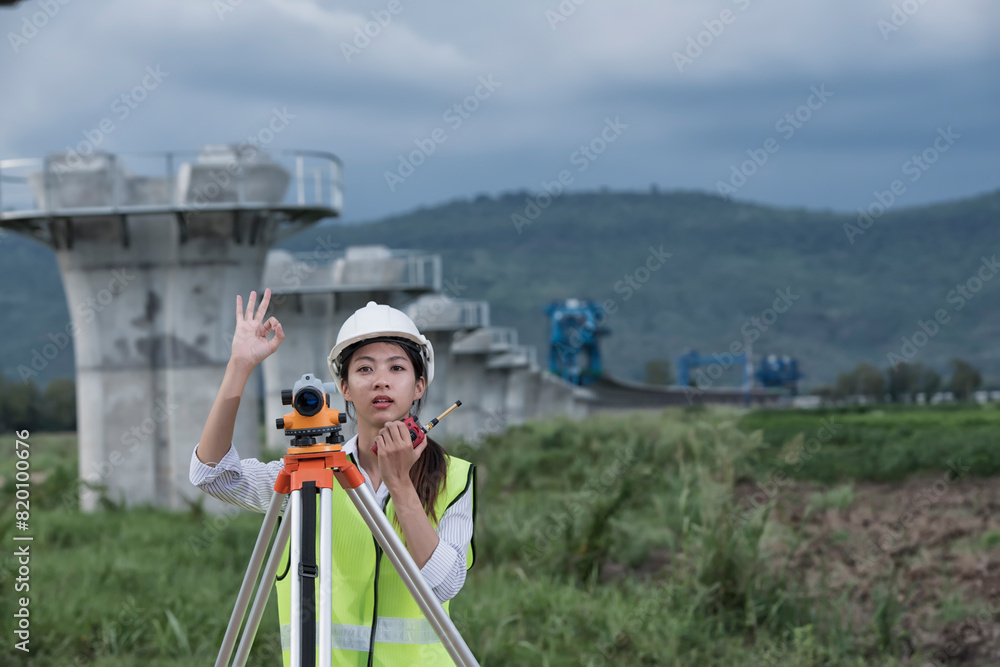 custom made wallpaper toronto digitalFemale Survey Engineer Using Leveling Camera on Construction Site: Precision and Expertise in Civil Engineering Projects. Female Land Surveyor Utilizing Leveling Camera.
