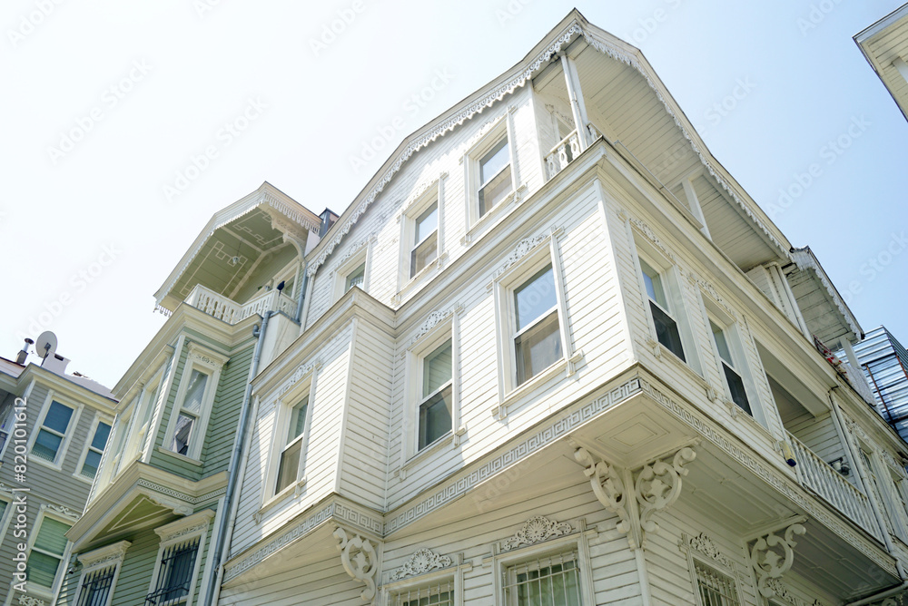 Bottom-up view of the old wooden houses of Istanbul. Street in Arnavutkoy district with traditional architecture - real estate in Istanbul, Turkey