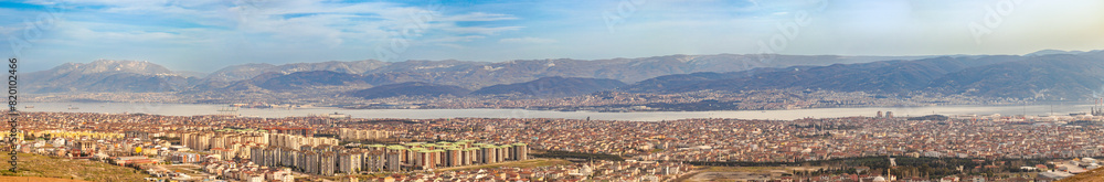 A very wide panoramic view of Kocaeli with its sea and mountains. Factory chimneys environmental pollution and city.