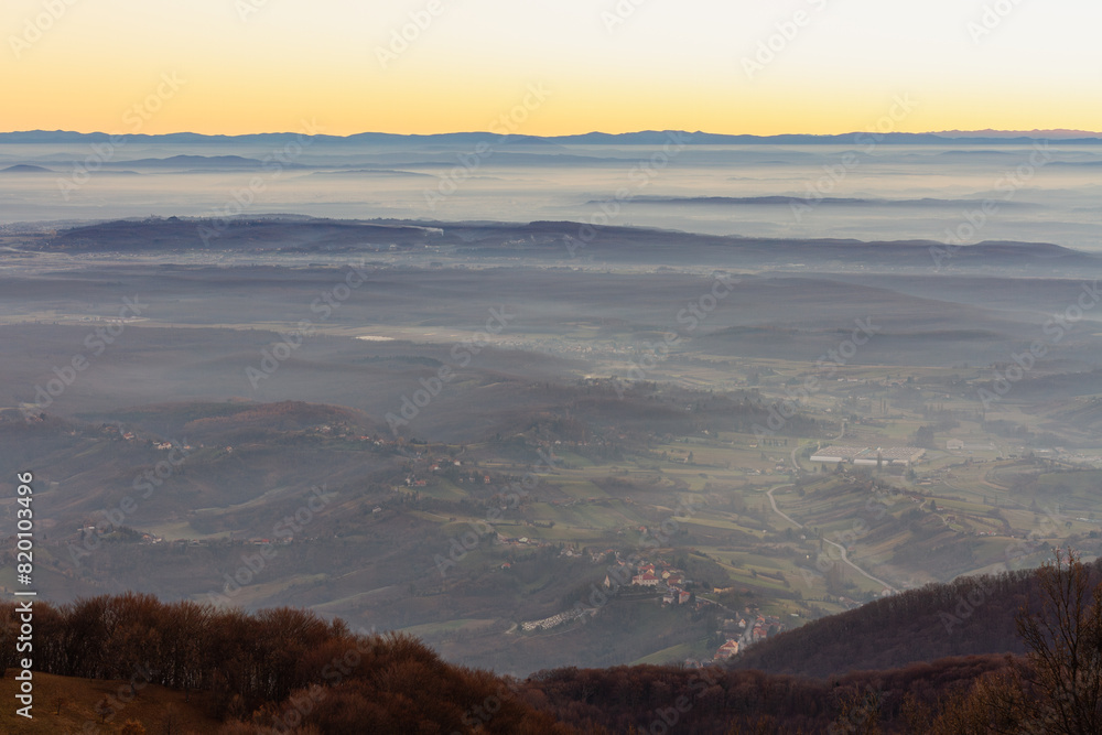 Misty Morning Over Expansive Valley with Distant Mountains Misty Morning Over Expansive Valley with Distant Mountains
