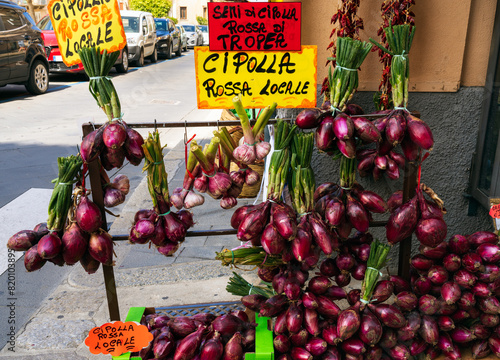 Sweet red purple onions displayed for sale on the street of the small seaside village Tropea, Italy.