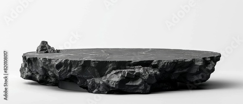 Rough black stone slab placed against a minimalistic white background, ideal for product display or architectural design concept.