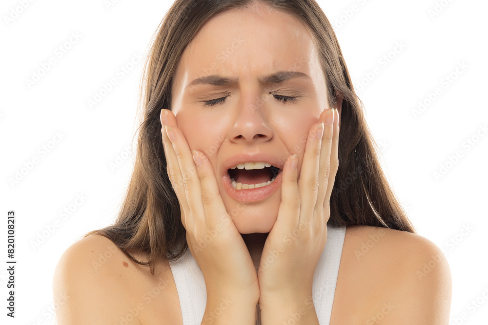 Portrait of a young unhappy teenage girl on a white background Portrait of a young unhappy teenage girl on a white background