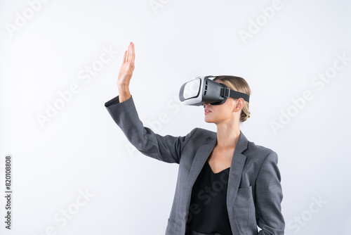 Smart business woman touching something while look though VR glass. Skilled project manager wearing suit and innovation technology visual reality goggles for connecting with metaverse. Contraption.