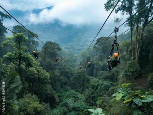 A group of people are ziplining through a forest. The trees are lush and green, and the sky is cloudy. Scene is adventurous and exciting